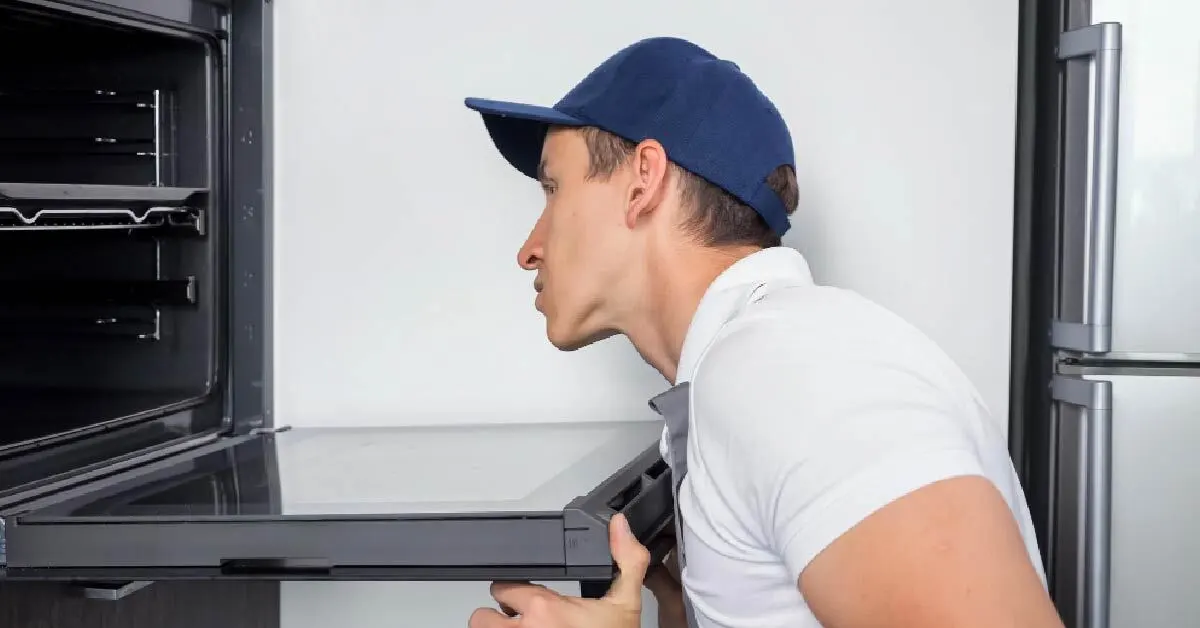 Our mechanic is checking a commercial refrigerator to find problems