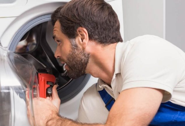 Washing machine maintenance by All State Appliance Repair employee